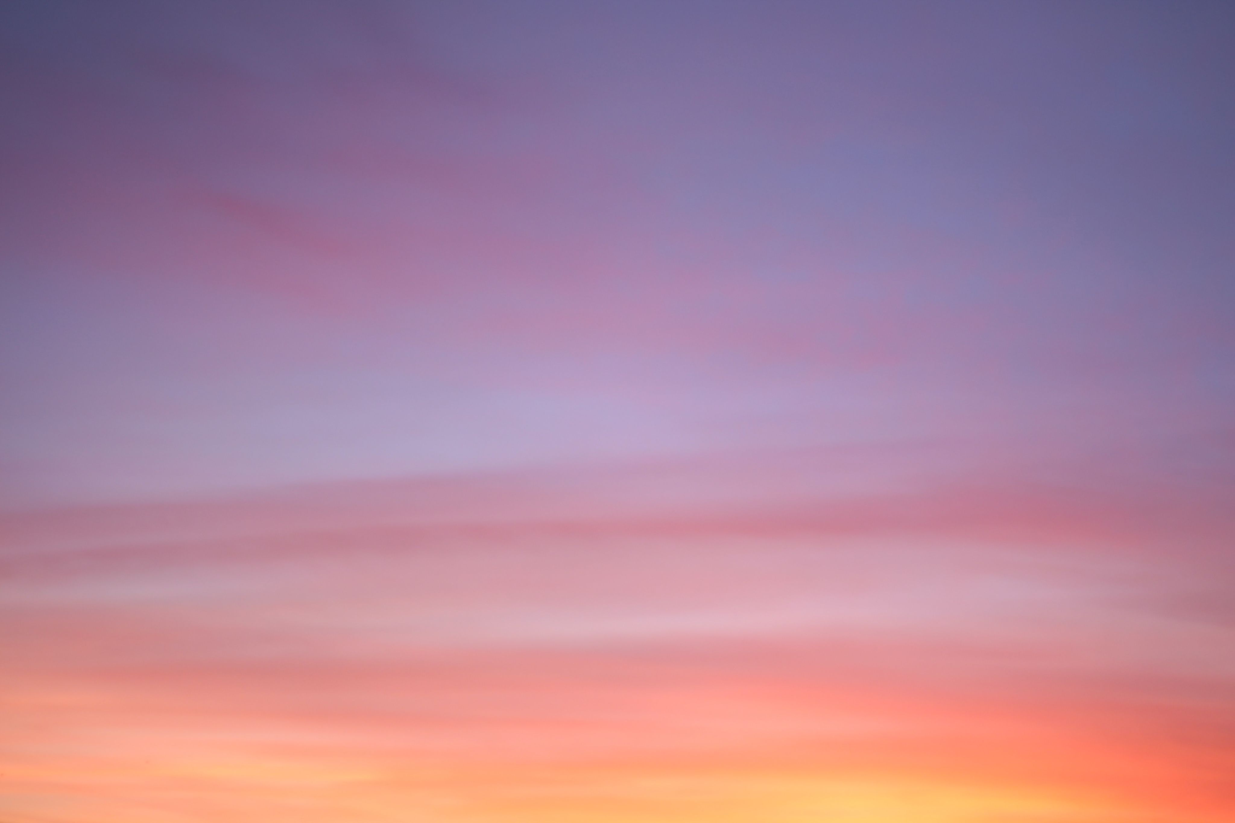 the sun is setting over a mountain range